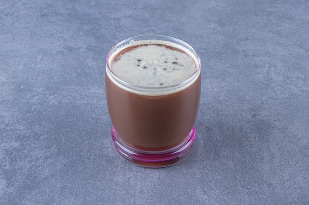 Delectable coffee in a glass , on the blue background.