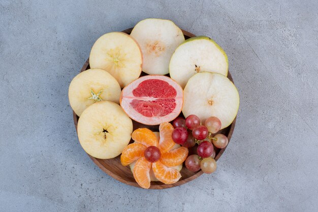 A delectable fruit serving on a small tray on marble background. 