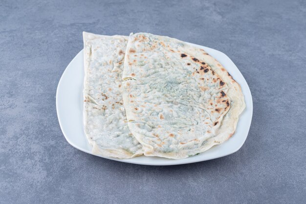 Delectable gutab on a plate on marble table.