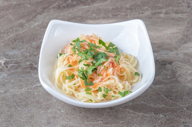 Delectable pasta in bowl , on the marble.