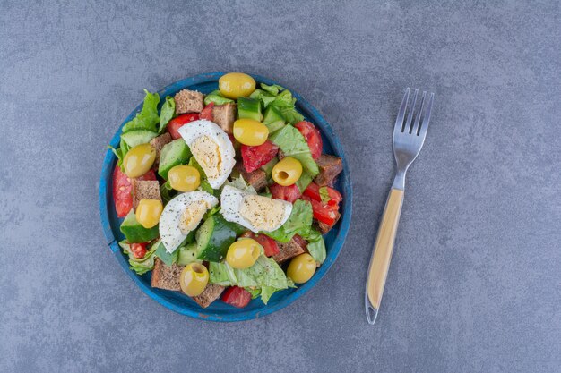 Delectable salad mix with breakfast ingredients on marble surface