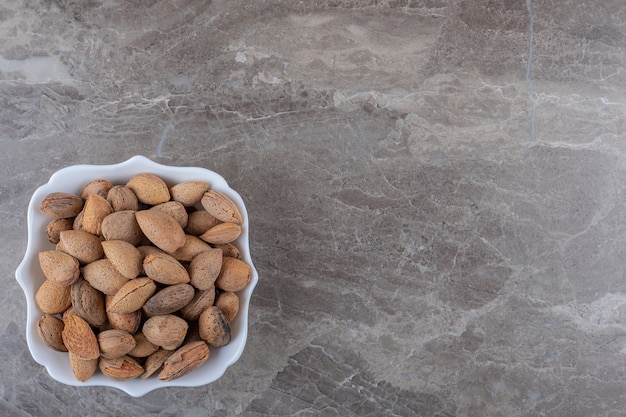 delicious-almonds-bowl-marble-surface_114579-79971.jpg