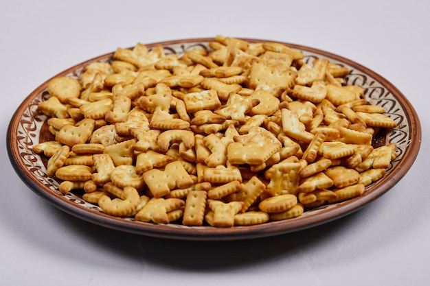 Delicious alphabet crackers on a ceramic plate.