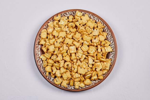 Delicious alphabet crackers on a ceramic plate.