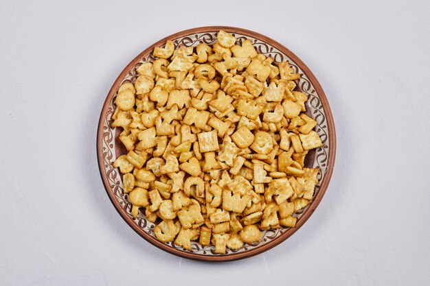 Delicious alphabet crackers on a ceramic plate.