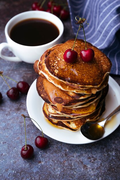 Delicious american pancakes with cherry on top