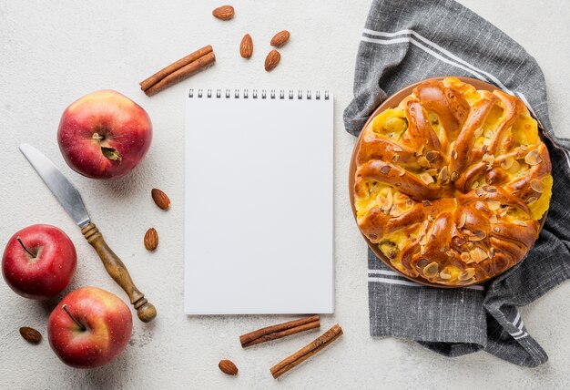 Delicious apple pie with notepad top view