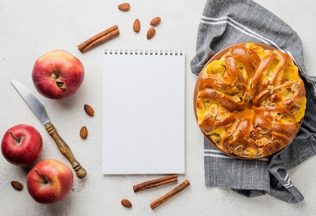 Delicious apple pie with notepad top view