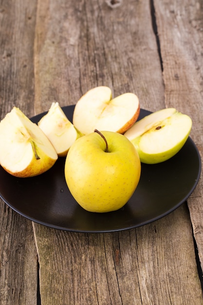 delicious apple on a plate over a wooden table