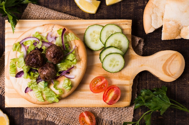 Delicious arabic fast-food meat rolls on focaccia top view