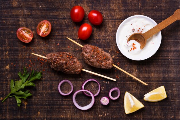 Delicious arabic fast-food meat on skewers flat lay