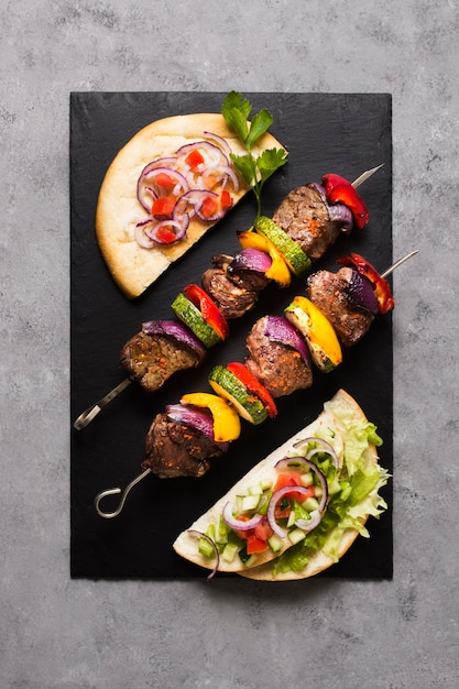 Delicious arabic fast-food top view ingredients on skewers