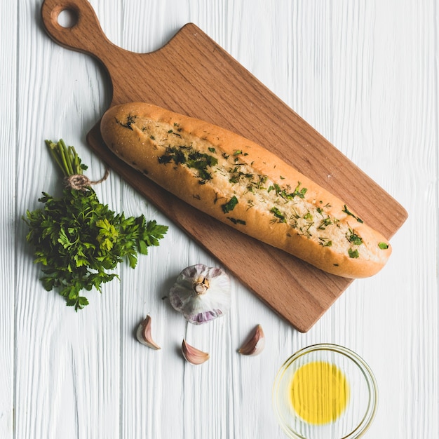 Delicious baguette with seasoning on board