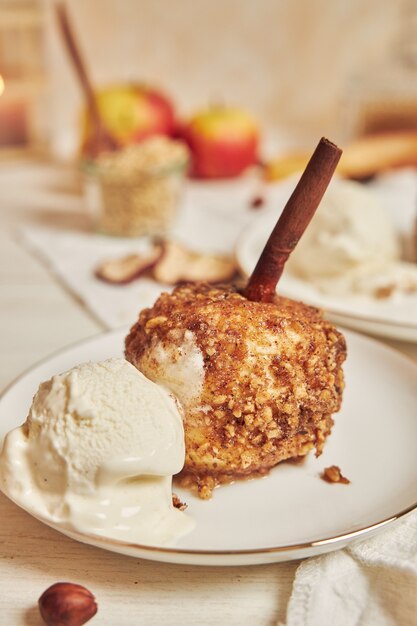 Delicious baked apple with nuts and cinnamon for Christmas on a white table