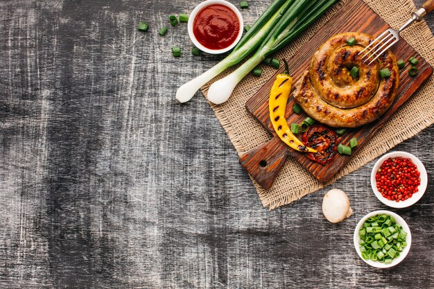 Delicious barbecue fast food on grey wooden table