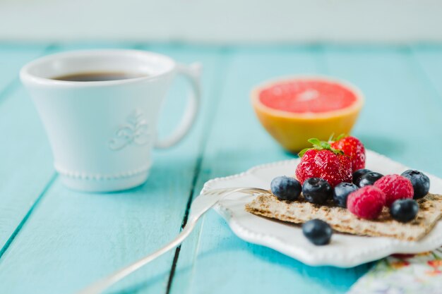 Delicious berries and cup of coffee