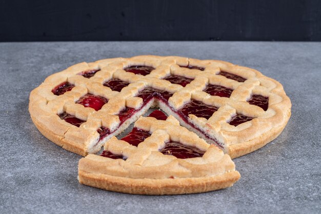 Delicious berry pie on marble surface
