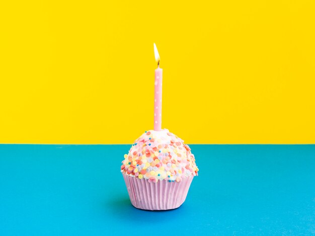 Delicious birthday muffin with pink candle