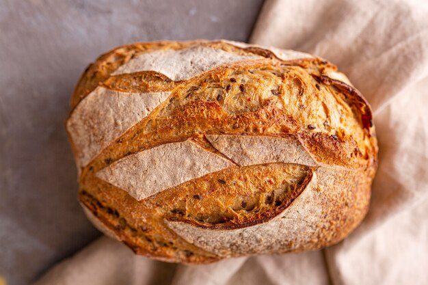 Delicious bread on towel flat lay