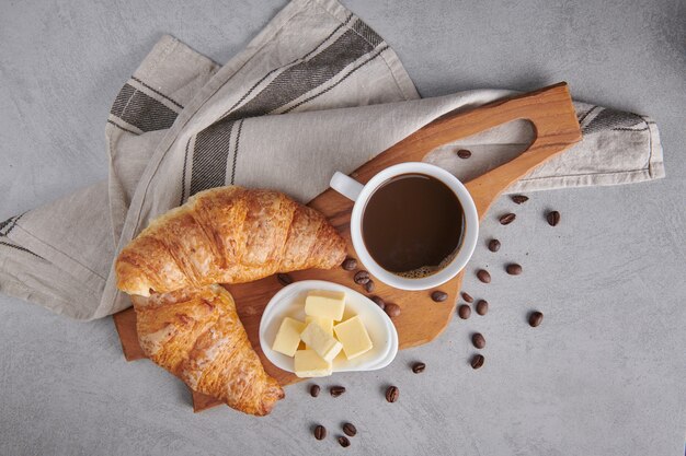 신선한 크루아상과 버터를 곁들인 커피로 구성된 맛있는 아침 식사
