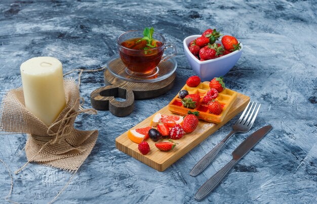 Delicious breakfast with waffle and fruits