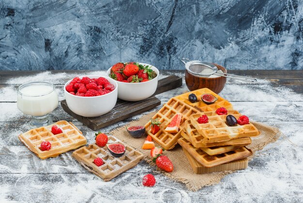 Delicious breakfast with waffles and fruits