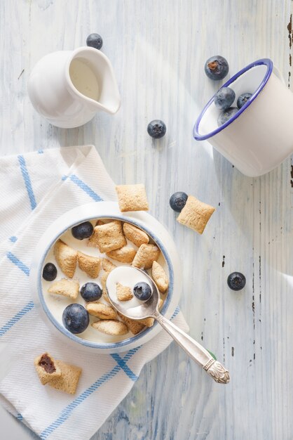 Delicious breakfast with a white ceramic mug on white table cloth