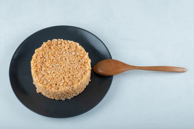 Delicious bulgur pilaf on dark plate.