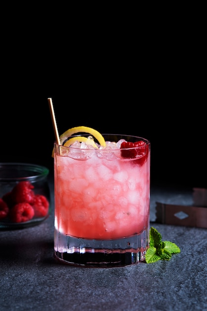 Delicious caipirinha cocktail with raspberry