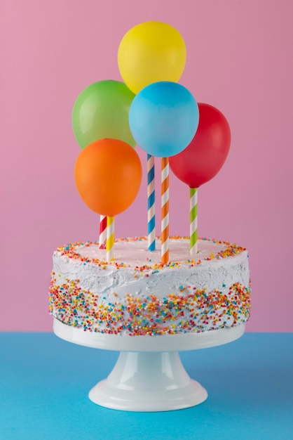 Delicious cake and colorful balloons