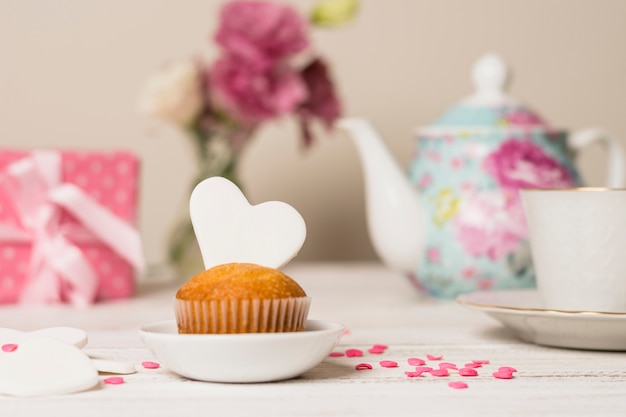 Delicious cake near teapot and cup