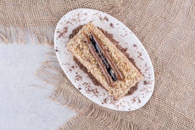 Delicious cake on white plate with burlap. High quality photo