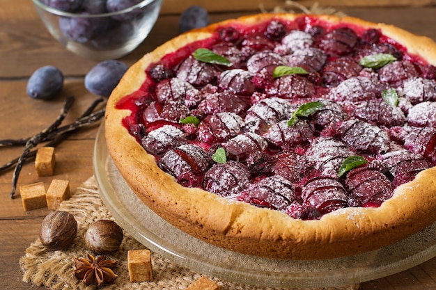 Delicious cake with fresh plums and raspberries