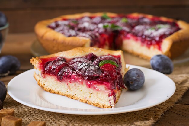 Delicious cake with fresh plums and raspberries