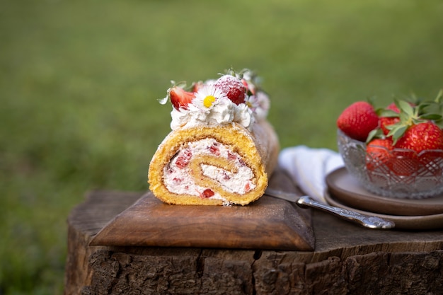 Free photo delicious cake with strawberries outdoors