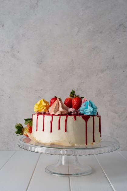 Delicious cake with strawberries on stand