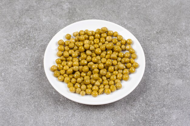 Delicious canned peas on white plate