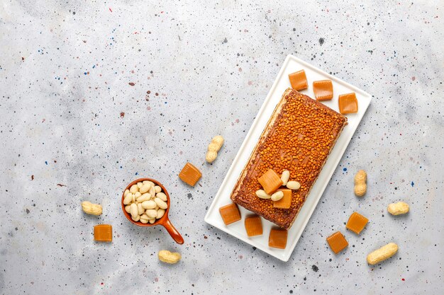 Delicious caramel and peanut cake with peanuts and caramel candies,top view