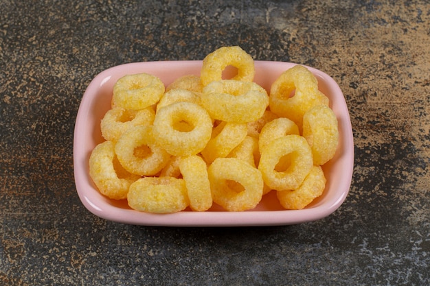 Delicious cereal rings in pink bowl. 