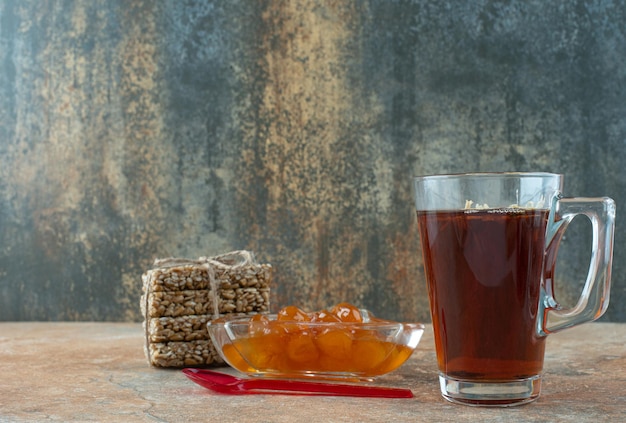 Delicious chamomile tea with peanut brittles and jam .