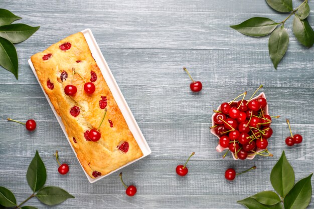 Delicious cherry cake with fresh cherries, top view