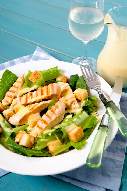 Delicious chicken caesar salad on picnic table