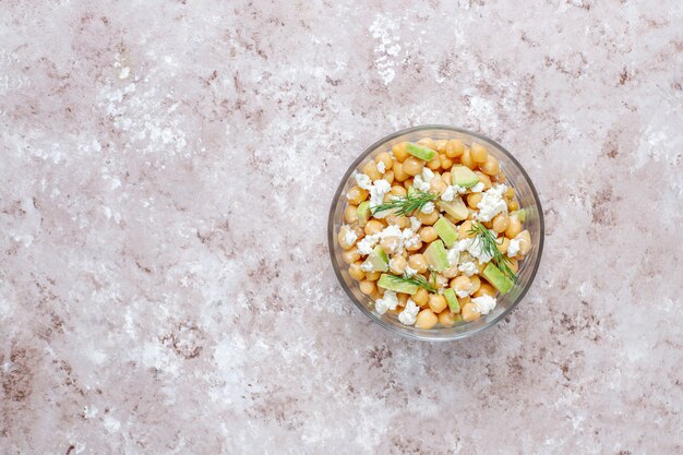 Delicious chickpea salad with avocado and feta cheese, top view