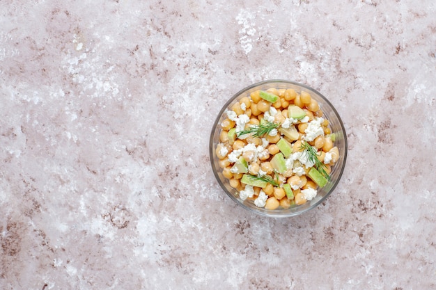 Delicious chickpea salad with avocado and feta cheese, top view