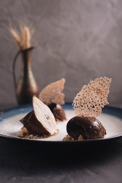 Delicious chocolate pastry with decoration on plate