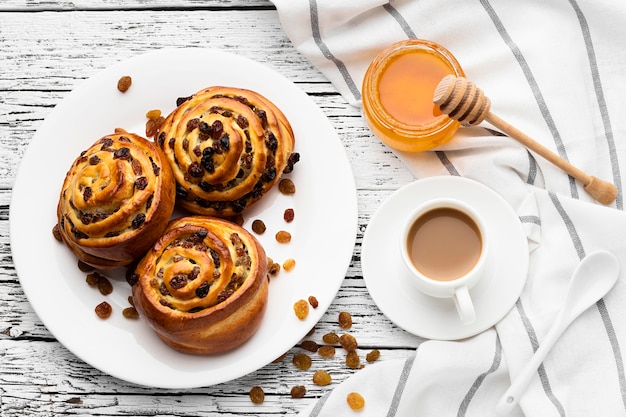 Delicious cinnamon raisins rolls on wooden table