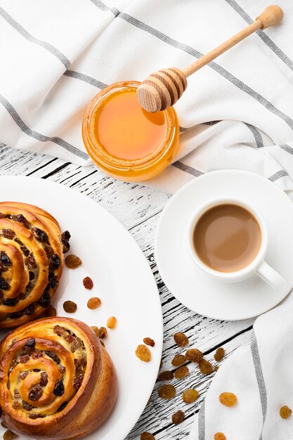 Delicious cinnamon raisins rolls on wooden table