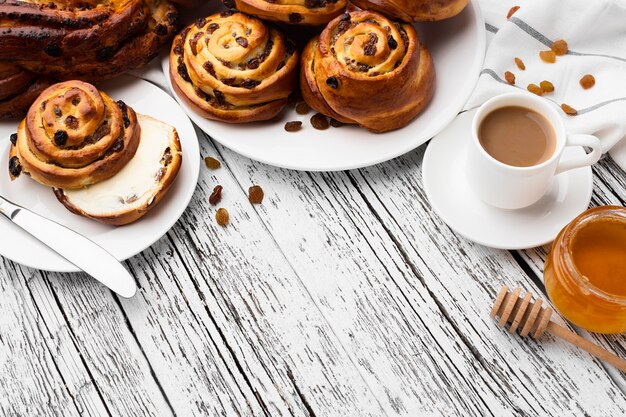 Delicious cinnamon raisins rolls on wooden table