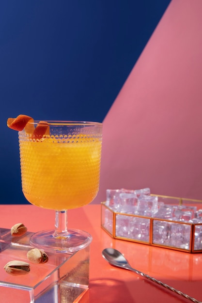 Foto gratuita delizioso cocktail con arancia e ghiaccio