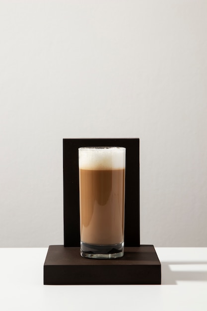 Delicious coffee with foam on wooden board